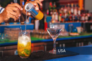 Bartender pouring an energy drink into a cocktail glass. Tagged 'USA'